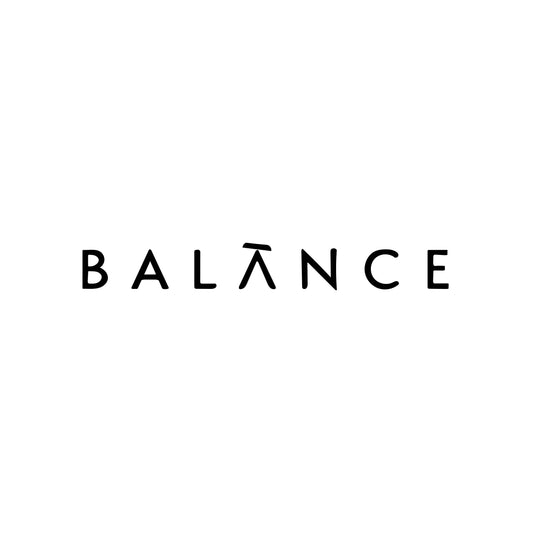 Modern black typographic tattoo design spelling 'BALANCE' in all caps, with a stylized 'A' featuring a macron accent, symbolizing harmony and mindfulness. Displayed on a white background.