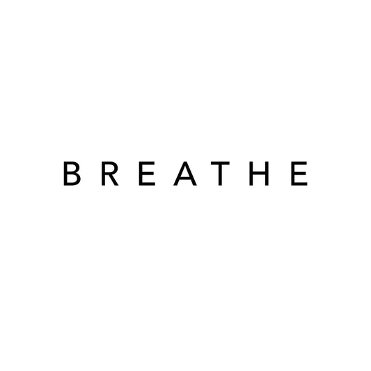 Minimalist black text tattoo design featuring the word 'BREATHE' in clean, all-uppercase lettering. A calming and mindful reminder rendered in a sleek, modern font style.